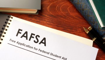 This stock illustration shows a piece of paper on a desk with the header FAFSA: Free Application for Federal Student Aid."