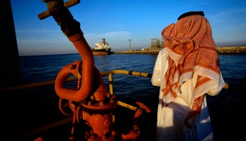 A man stands on a platform on an oil and gas terminal in January 2003 in the Persian Gulf off of Ras Tanura, Saudi Arabia.