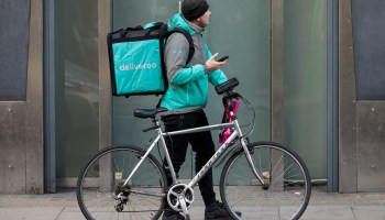 A Deliveroo rider makes a food delivery on February 16, 2018 in London, England.