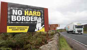 A sign in Northern Ireland reads: "No Hard Border: Border Communities Against Brexit."