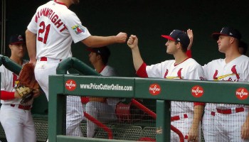 Anthony Shew (right) fist bumps fellow pitcher Adam Wainwright while playing for the minor league Springfield Cardinals. As a minor league player, Shew isn't subject to federal minimum wage and overtime requirements.