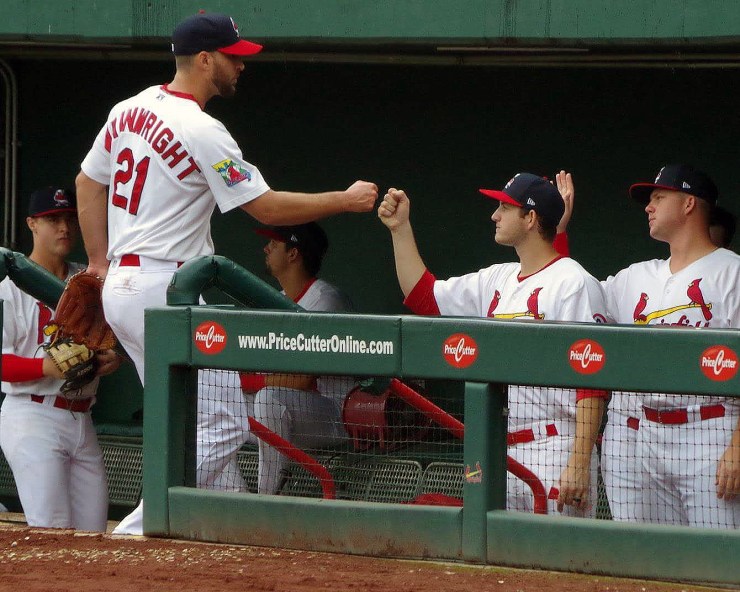Anthony Shew (right) fist bumps fellow pitcher Adam Wainwright while playing for the minor league Springfield Cardinals. As a minor league player, Shew isn't subject to federal minimum wage and overtime requirements.