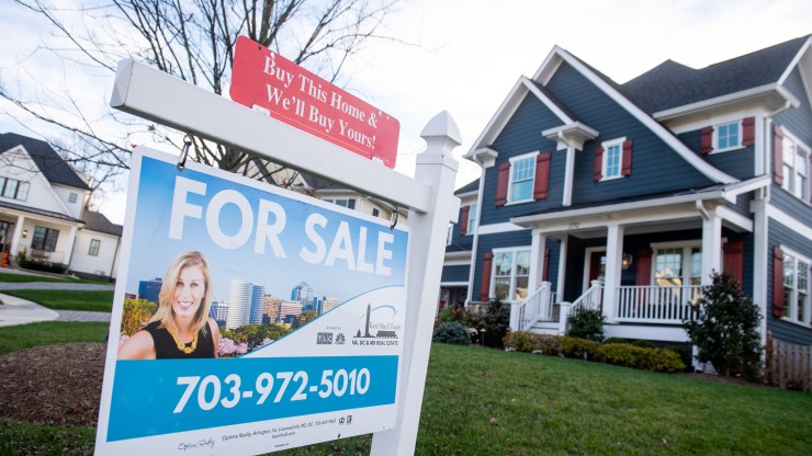 A house's real estate for sale sign is seen in front of a home in Arlington, Virginia, Nov. 19, 2020.