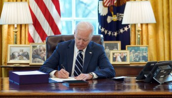 President Joe Biden signs the American Rescue Plan in the Oval Office. He has drawn broad support for his management of the coronavirus response.