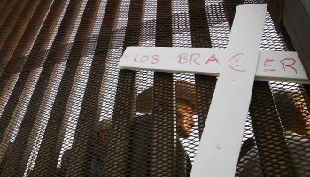 A white cross with the words "Los Braceros" across the front.
