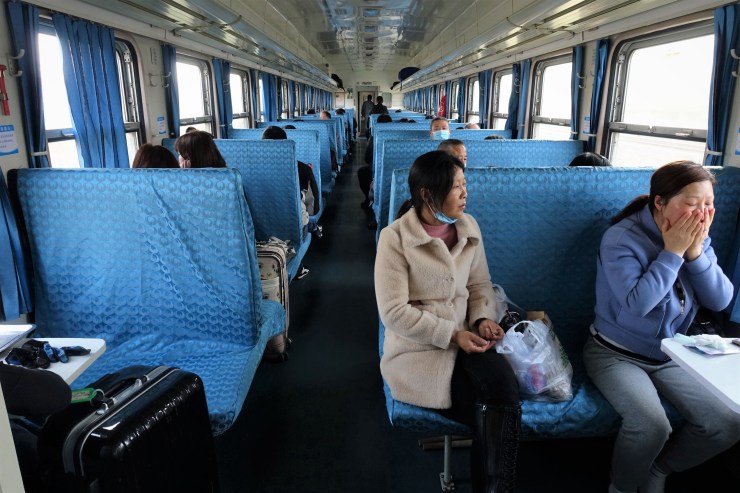 A passenger on Train 8324 in central Henan province washes her face on board during the ride into the countryside. (Charles Zhang/Marketplace)