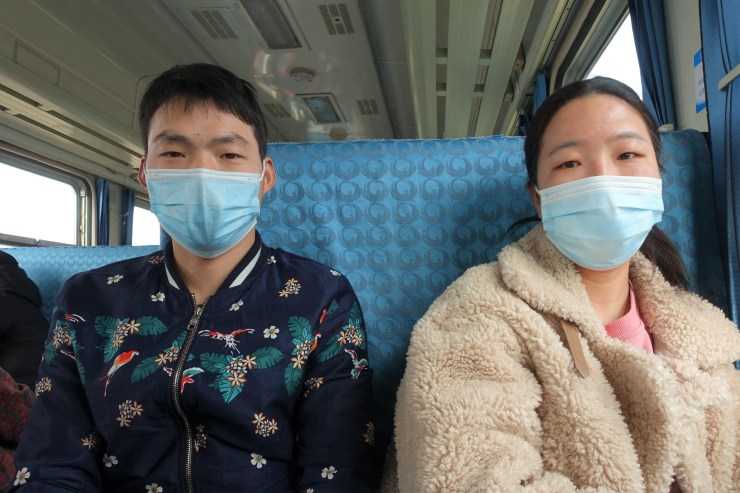 Fu Sihu (left) and wife, Li Hong, are on their way back to the village after seeing a city doctor. The couple do not usually live together because Fu can earn more working in bigger cities. (Charles Zhang/Marketplace)
