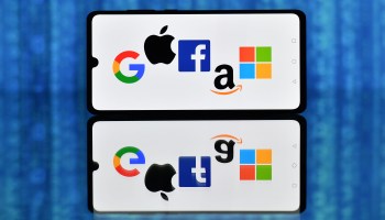 This photo illustration shows the logos of Google, Apple, Facebook, Amazon and Microsoft displayed on a mobile phone.