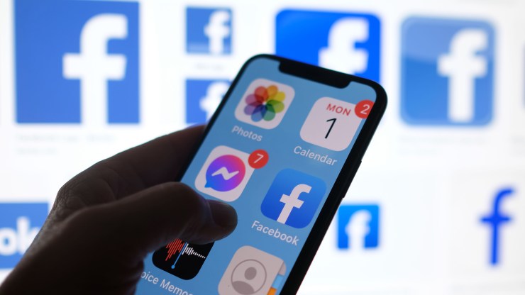 This illustration photo shows a Facebook App logo displayed on an iPhone in Los Angeles, March 1, 2021.