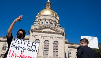 Demonstrators stand outside of the Capitol building in opposition to House Bill 531 on March 8, 2021 in Atlanta, Georgia.
