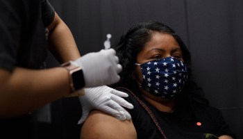 Farmworker Monica Mateo receives a dose of the Pfizer COVID-19 vaccine at a vaccination site organized by the United Farm Workers, Kern Medical and the Kern County Latino COVID-19 Task Force inside Reuther Hall at Forty Acres on March 13, 2021 in Delano, California.