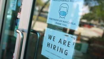 A "We are hiring" sign in front of a store on March 5, 2021 in Miami, Florida.