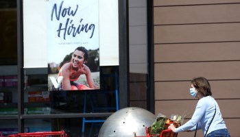 A pedestrian walks by a now hiring sign at a The Vitamin Shoppe on April 02, 2021 in Larkspur, California.