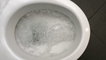Water pours down the toilet on January. (Photo illustration by Christof Koepsel/Getty Images)