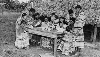 A Seminole family displays their pottery outside their home in the Florida Everglades in 1974.