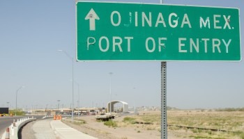 A road sign reads "Ojinaga Mex. Port of Entry."