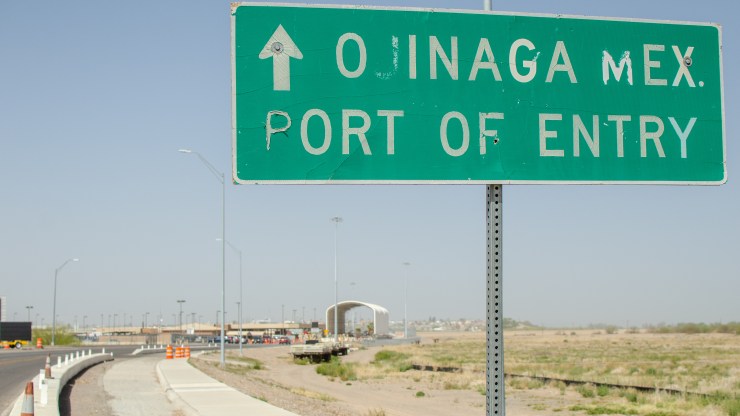 A road sign reads "Ojinaga Mex. Port of Entry."