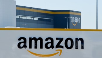 This picture shows a sign of Amazon's logo at Amazon's center entrance as Amazon France partially reopens amid the coronavirus pandemic.