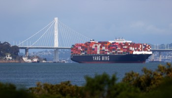 A fully-loaded container ship sits anchored in the San Francisco Bay in March.