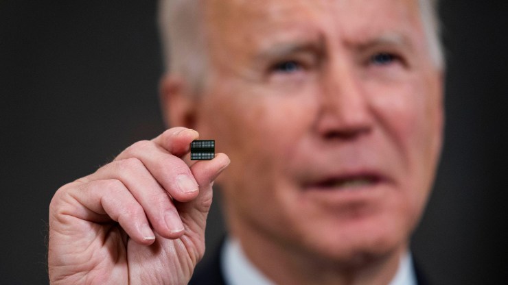President Joe Biden holds a semiconductor during his remarks before signing an executive order on the economy in the State Dining Room of the White House on February 24, 2021.