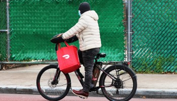 A Doordash delivery person rides their bike on Church Avenue in the Flatbush neighborhood of Brooklyn on December 4, 2020 in New York City.