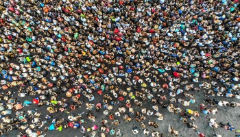 A large crowd of people looking in the same direction, as seen from above.