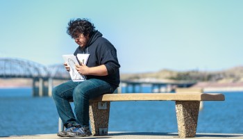 A student sits on a bench.