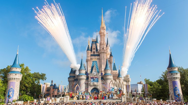 Fireworks go off behind Cinderella's castle at Disney World