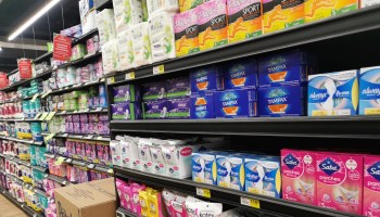 Grocery store shelves of female sanitary products.