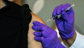 A person gets a vaccination in their arm.