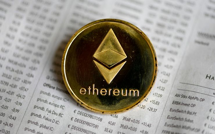 A gold coin with ethereum written on it.