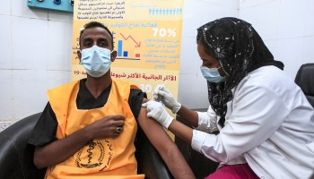 A medical worker receives a dose of the Oxford-AstraZeneca COVID-19 vaccine at the Jabra Hospital for Emergency and Injuries in Sudan's capital Khartoum on March 9, 2021.