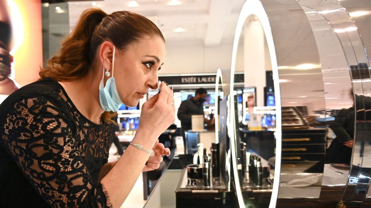 A customer tries on makeup in a department store.