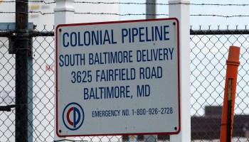 A Colonial Pipeline sign hangs on a fence at Colonial Pipeline Baltimore Delivery in Maryland.