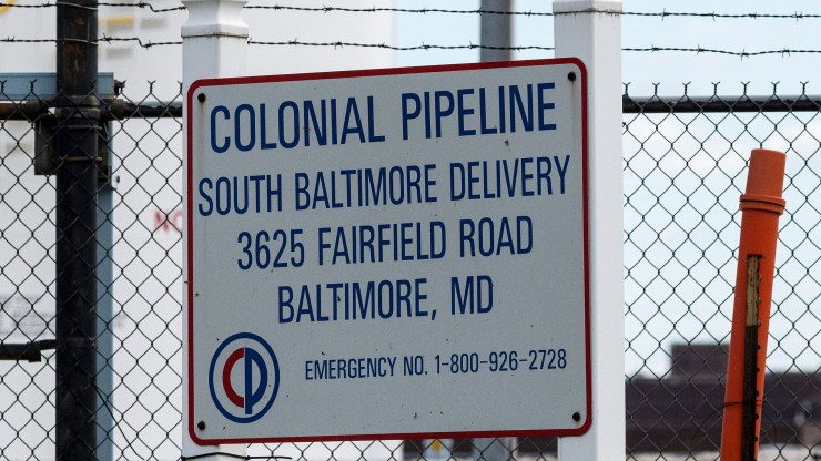A Colonial Pipeline sign hangs on a fence at Colonial Pipeline Baltimore Delivery in Maryland.