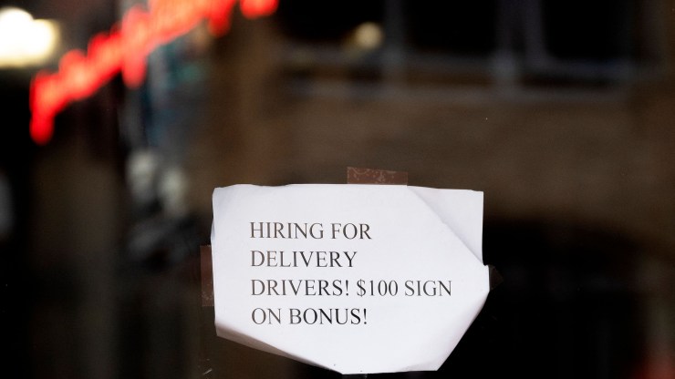 A sign on a restaurant window in Annapolis, Maryland, advertises that it's hiring for delivery drivers and offering $100 signing bonuses.