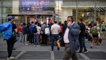 Shoppers line up outside a show store in central Manhattan, New York City, on May 19, 2021.
