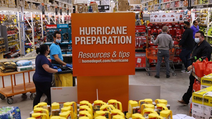 Home Depot customers walk past hurricane preparation supplies for sale on May 27, 2021 in Doral, Florida.