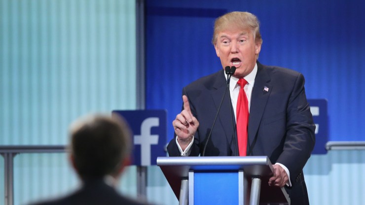Then-Republican presidential candidate Donald Trump fields a question during a debate standing at a lectern at the Quicken Loans Arena on August 6, 2015 in Cleveland, Ohio.