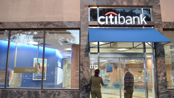A couple stands outside a Citibank branch in Washington, D.C.