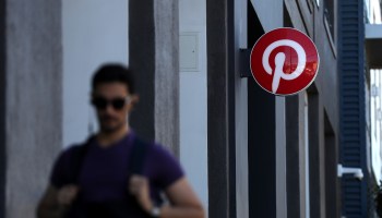 A pedestrian walks by the Pinterest headquarters on April 9, 2019 in San Francisco, California.