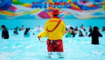 A lifeguard watches over the wave pool.