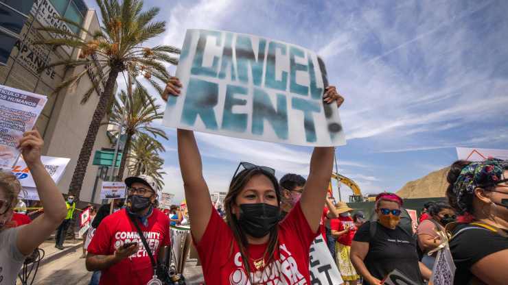 A woman calls for rent relief as a coalition of activist groups.