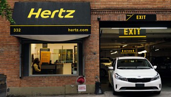 A Hertz car rental agency. Rental rates and the prices of used cars could remain high over the summer.