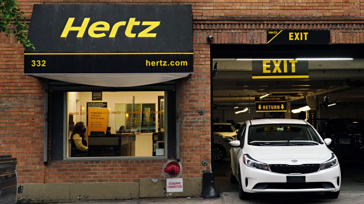 A Hertz car rental agency. Rental rates and the prices of used cars could remain high over the summer.