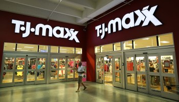 A person walks past a T.J. Maxx store.