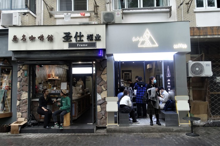 There are at least half a dozen other coffee shops within a one mile radius of Shanghai's Nameless Coffee (left), including one to its right (Charles Zhang/Marketplace)
