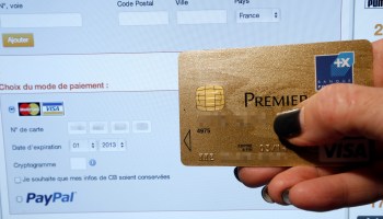 A person makes an online payment using a credit card.