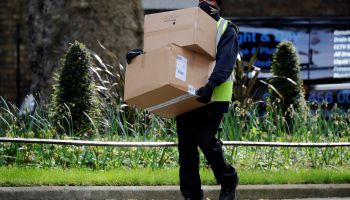 A Hermes delivery courier carries boxes as he makes a delivery to 10 Downing Street, the official residence of Britain's Prime Minister, in central London on May 5, 2020.