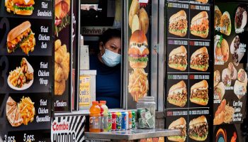 A worker looks out the window of a food truck for customers in Washington, D.C., on May 14, 2021.